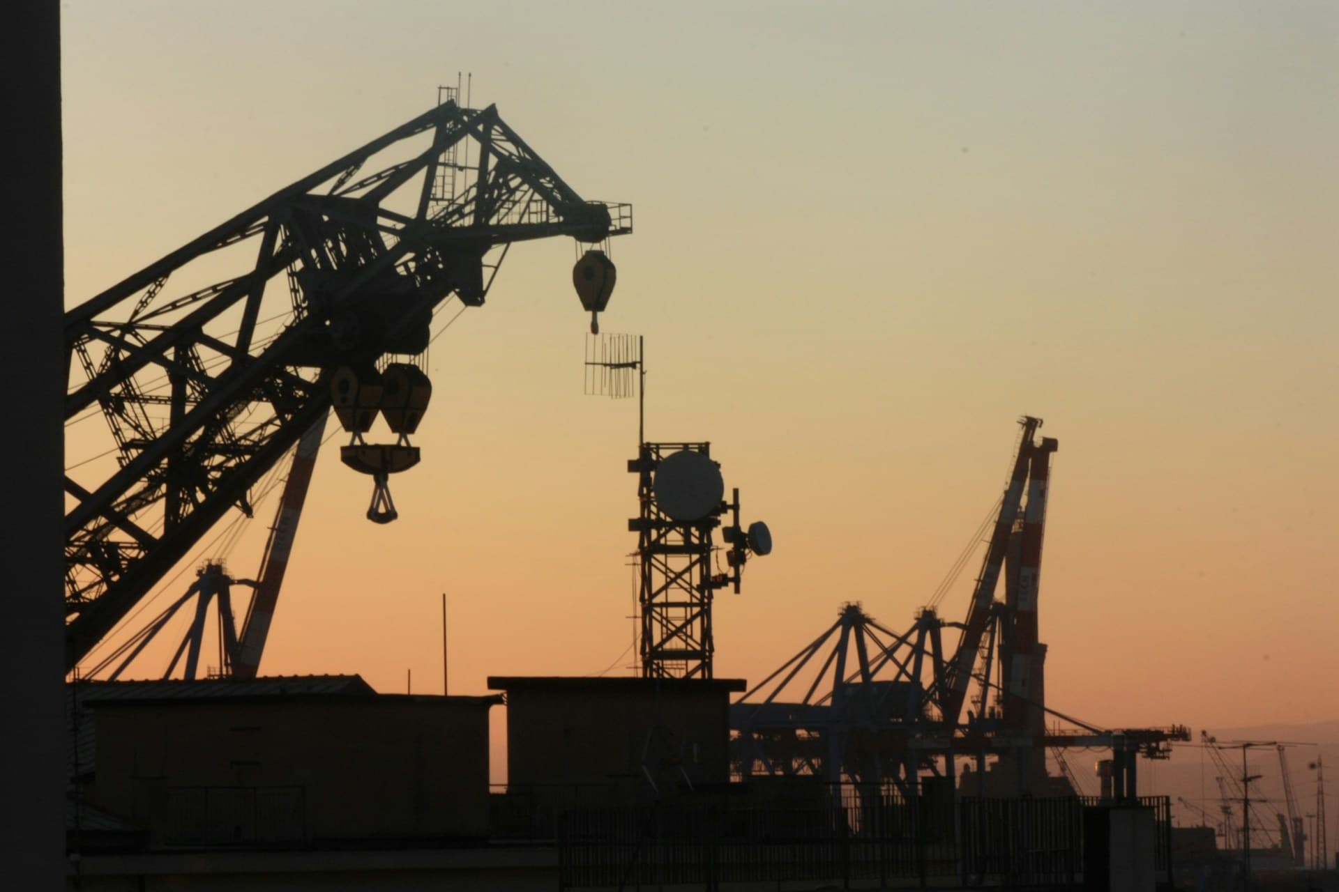 Mobile crane and heavy equipment operating on a UAE construction site at dawn