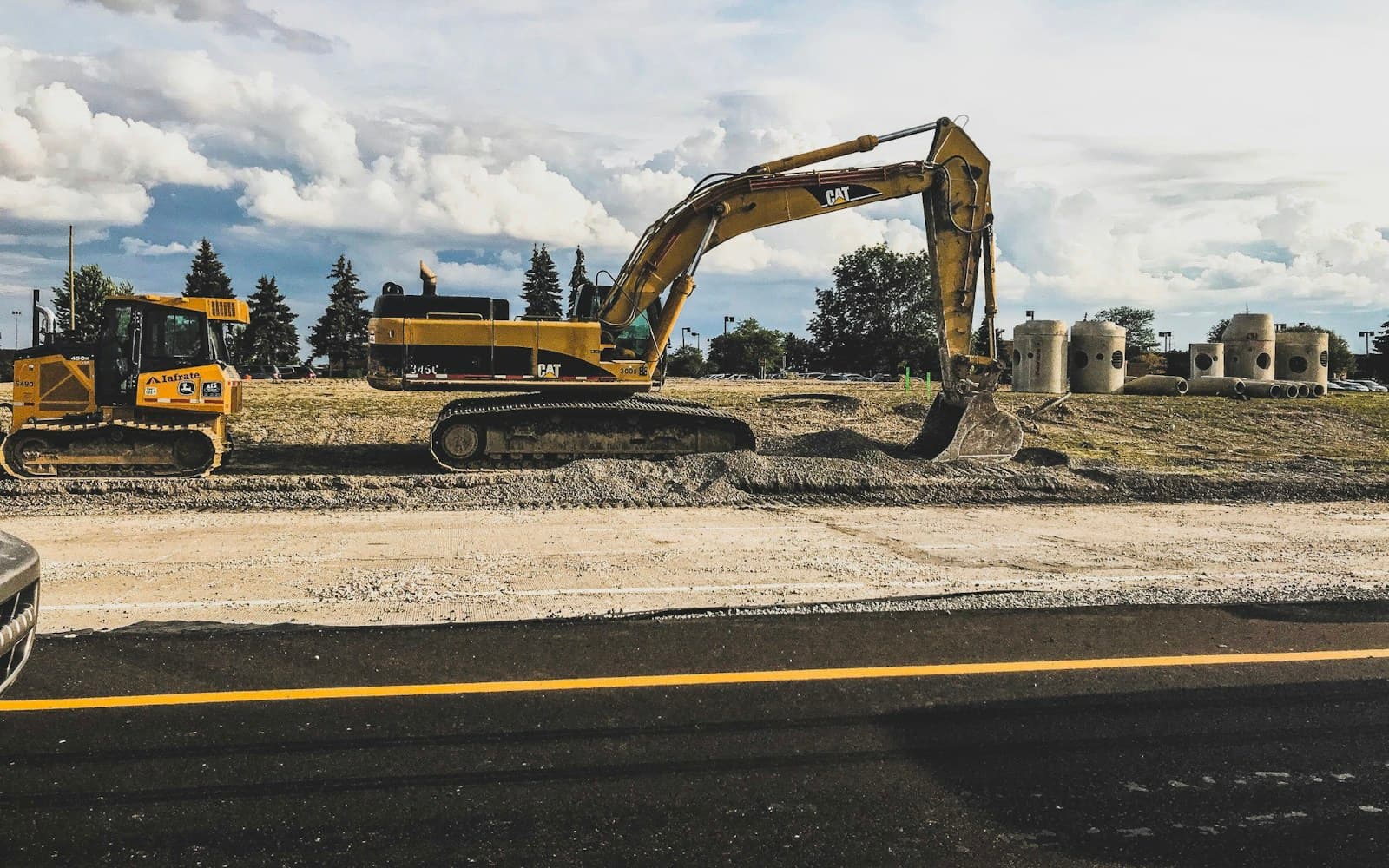 Excavator moving earth on a UAE infrastructure project at sunrise