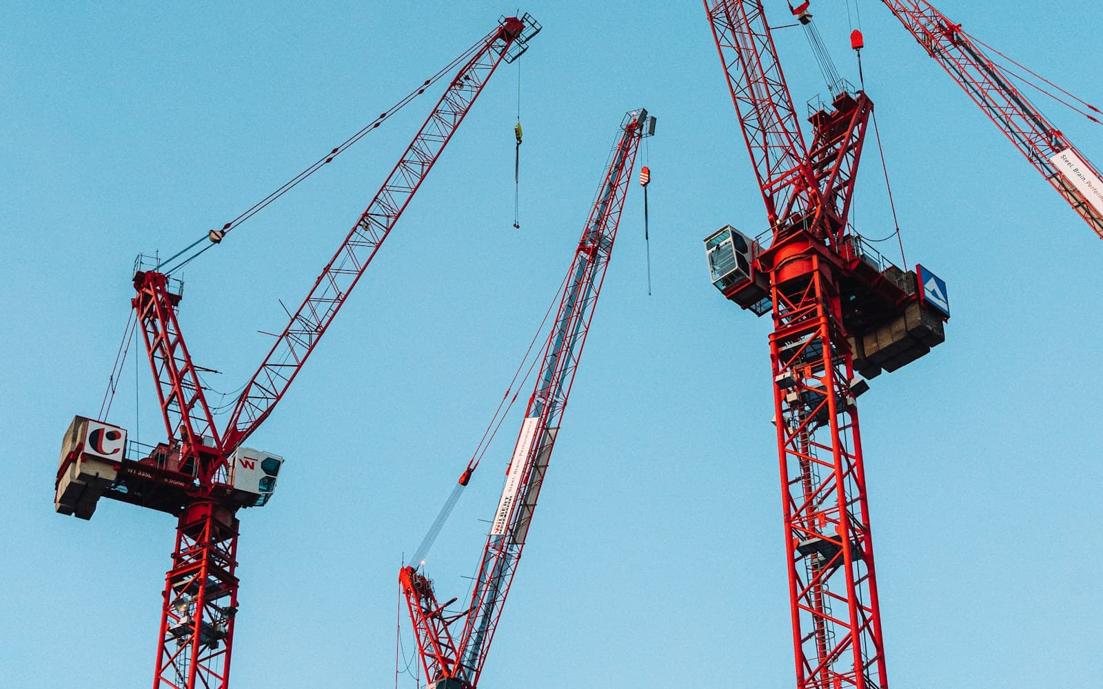 Mobile crane lifting steel structural framing on a UAE construction site