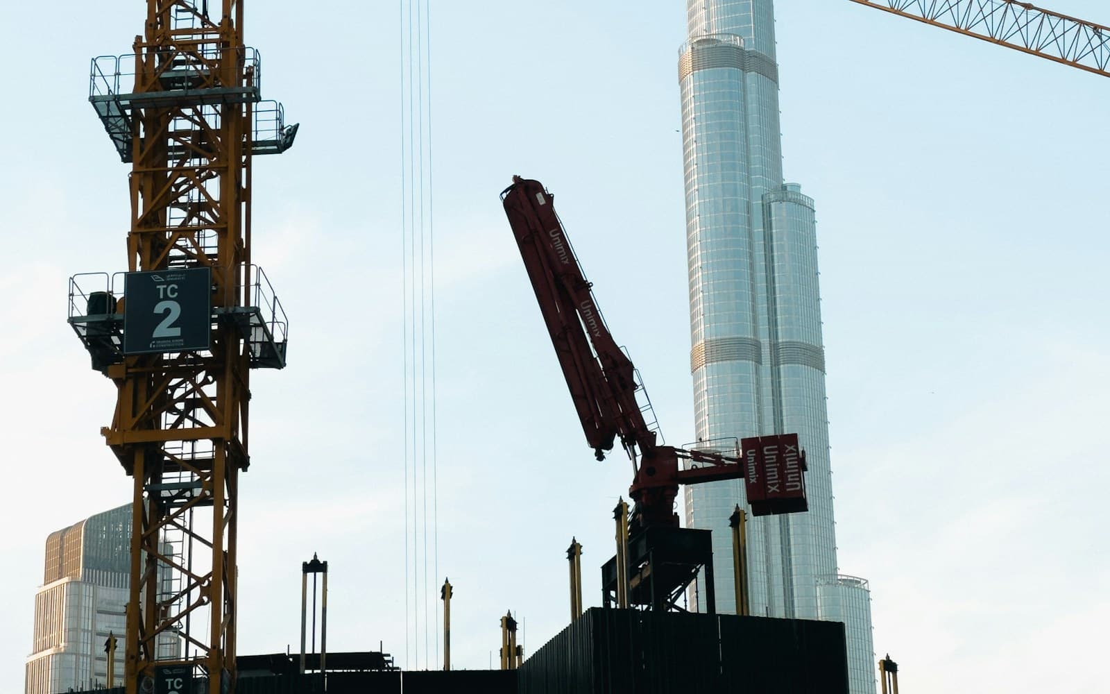 Boom lift working against a Dubai high-rise façade under construction