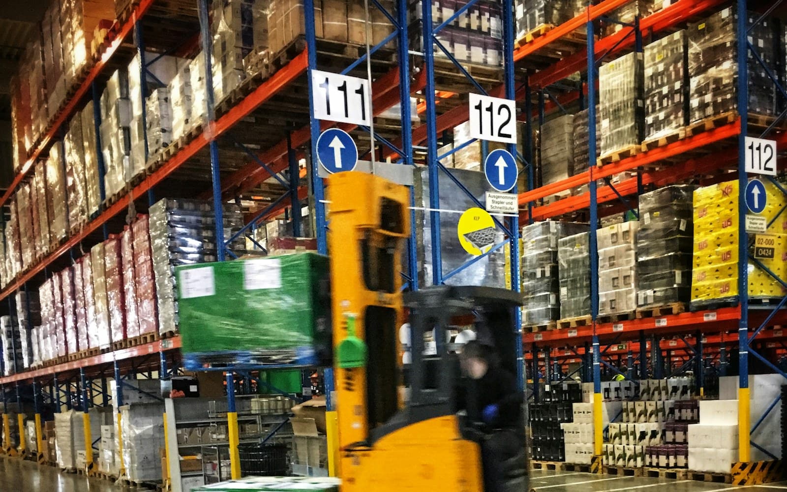 Forklift and crane supporting machinery relocation inside an ICAD manufacturing plant